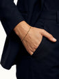 Woman wearing the Anchor Twist Chain Bracelet, hand in her pocket