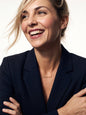 Woman laughing, wearing the Signature Name Necklace