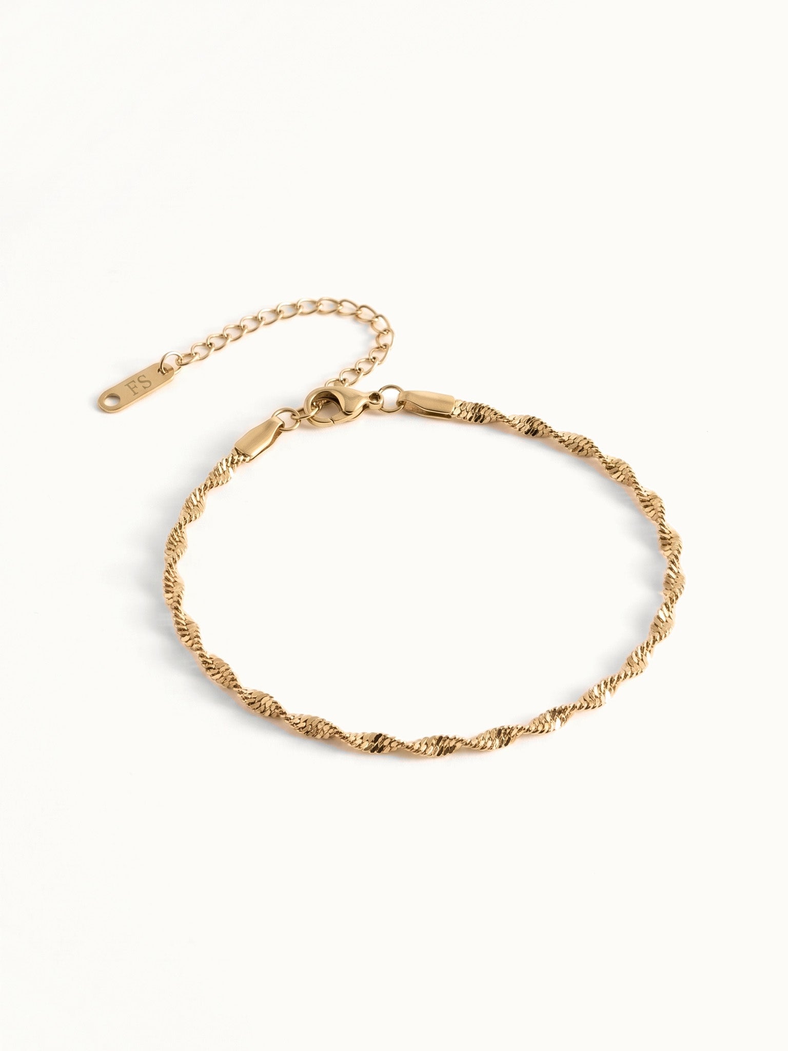 Anchor Twist Chain Bracelet – flat lay with clasp and extender, angled view, gold, on ivory background
