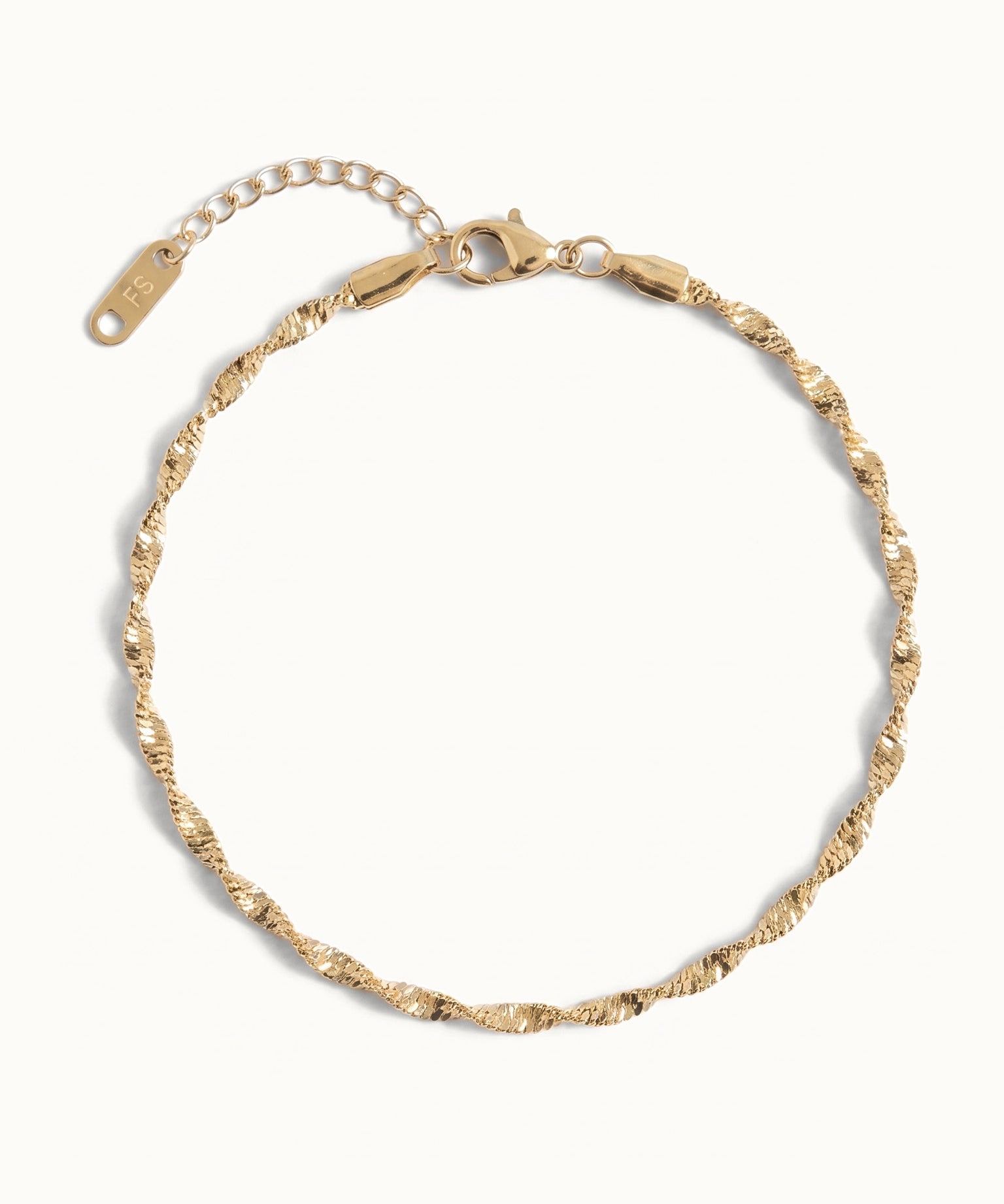 Anchor Twist Chain Bracelet – laid in a circle, seen from above, gold, on ivory background