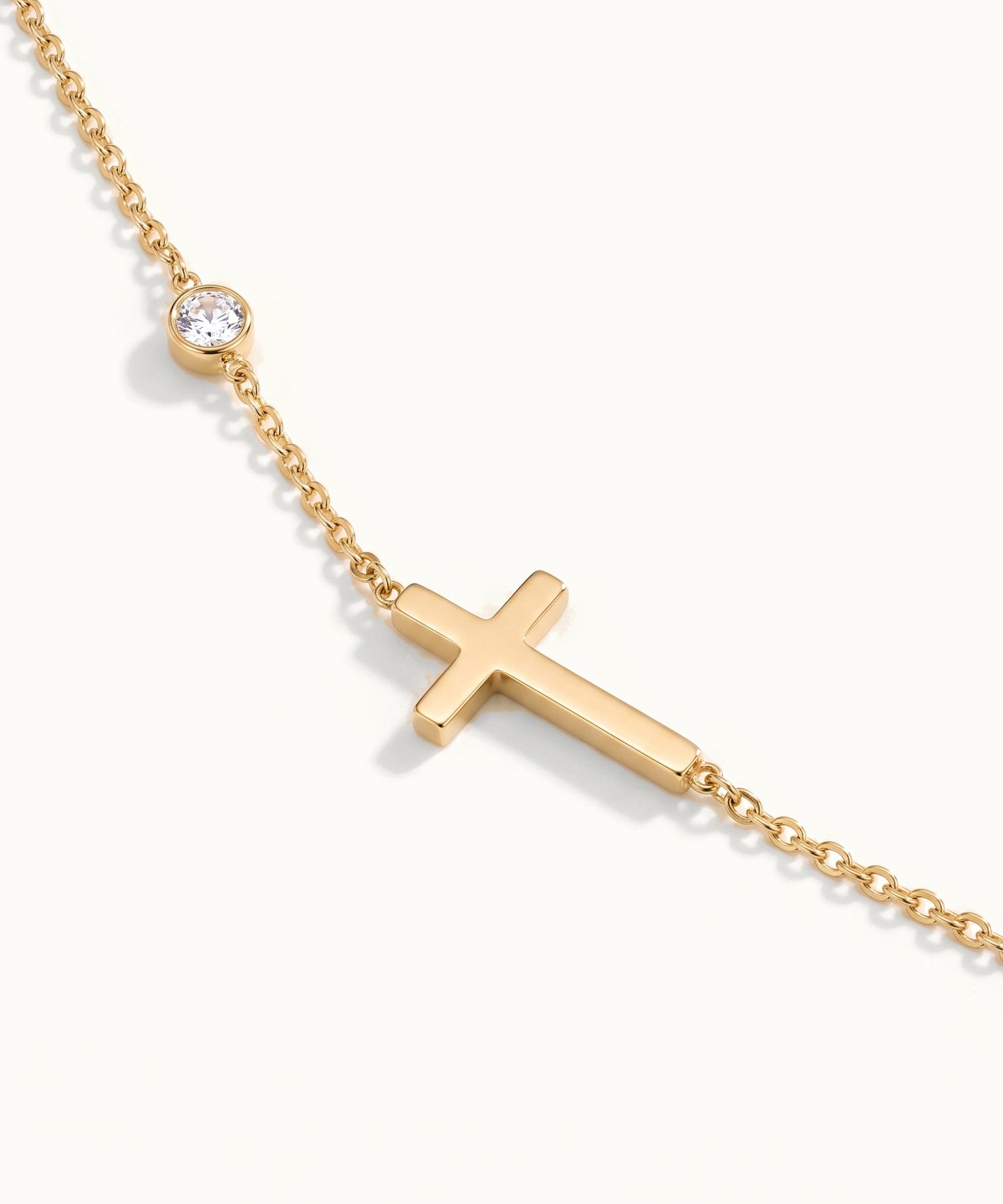 Beside Me Cross Bracelet in gold, close-up of the cross and stone