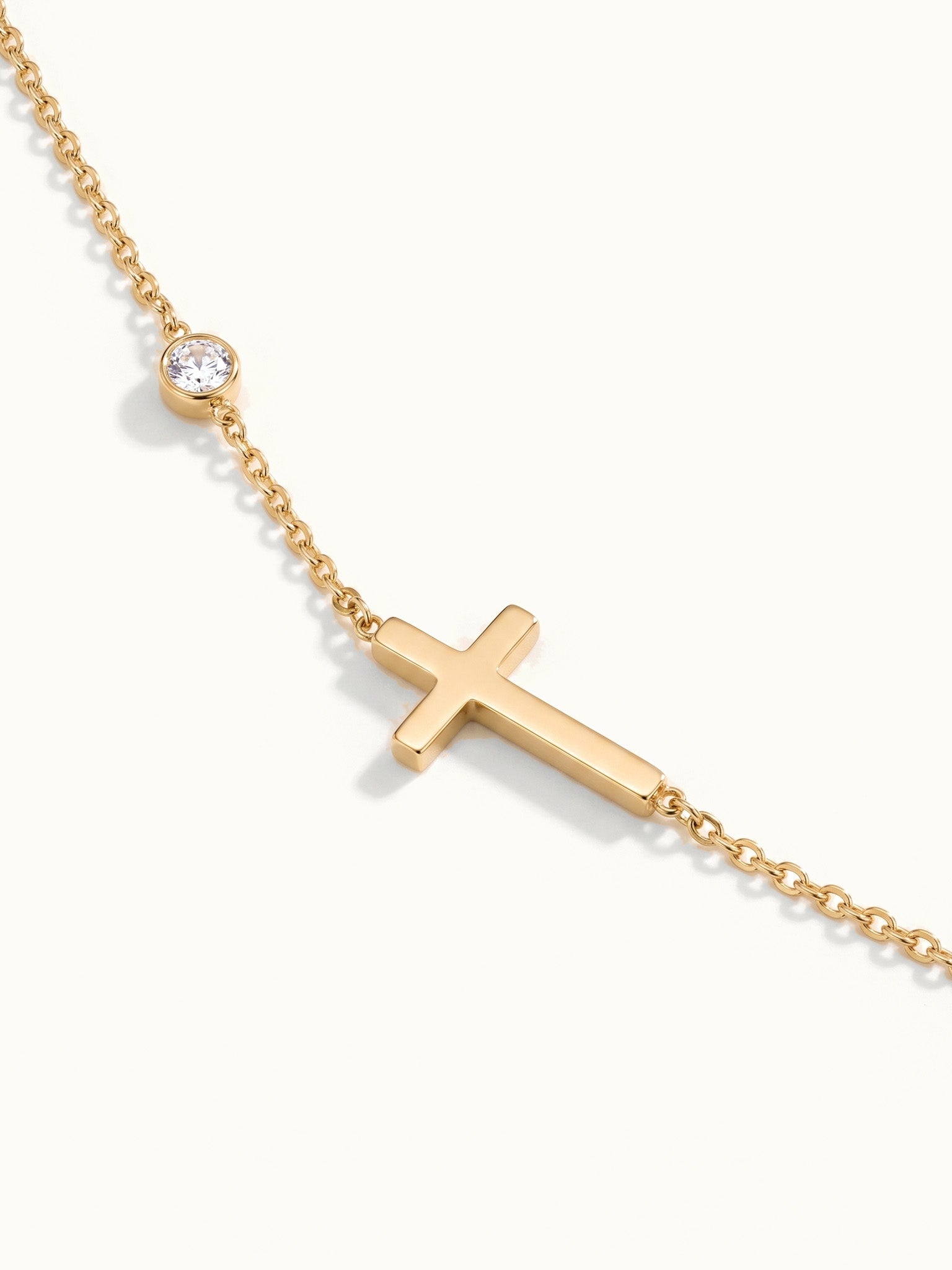 Beside Me Cross Bracelet in gold, close-up of the cross and stone
