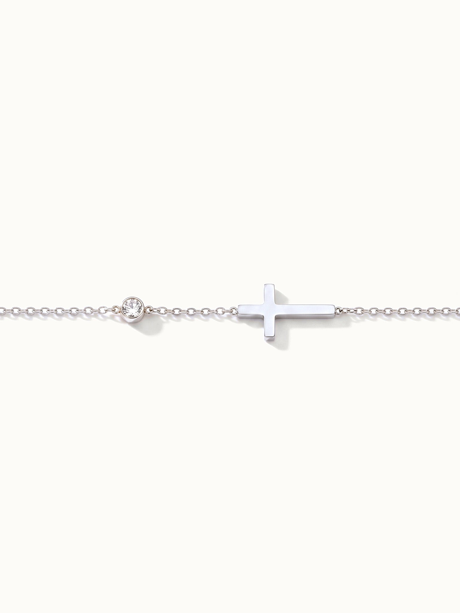Beside Me Cross Bracelet in silver, laid straight with the cross and stone
