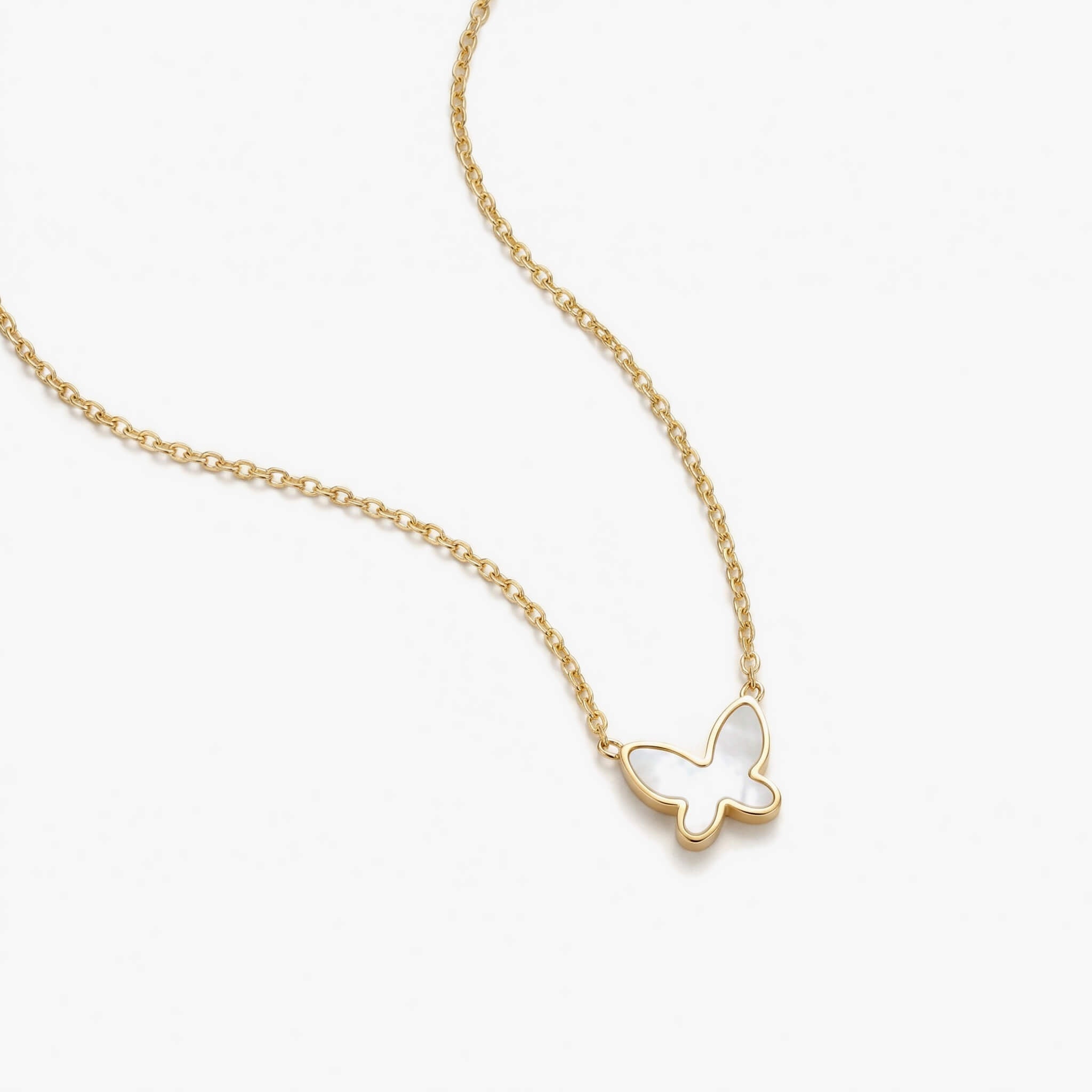 Close-up of New Season Butterfly Necklace pendant in gold with mother-of-pearl inlay