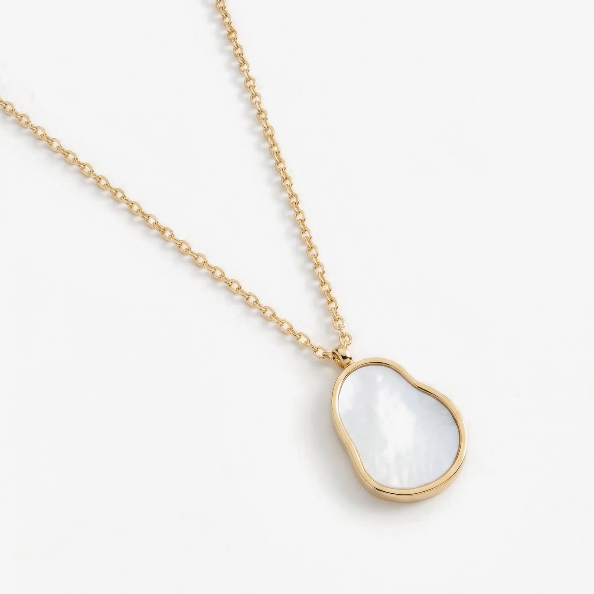 Dawn Pearl Pendant Necklace in gold, angled view of the mother-of-pearl pendant