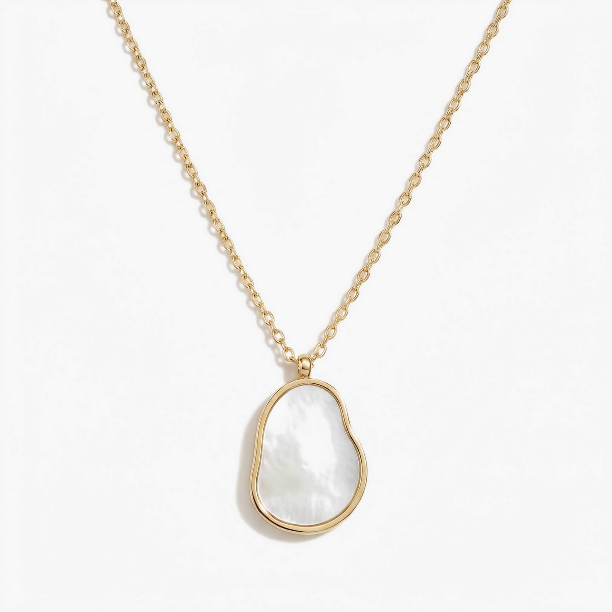 Dawn Pearl Pendant Necklace in gold with an organic-shaped mother-of-pearl pendant