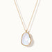 Dawn Pearl Pendant Necklace – mother-of-pearl pendant hanging on a fine chain, gold, on ivory background