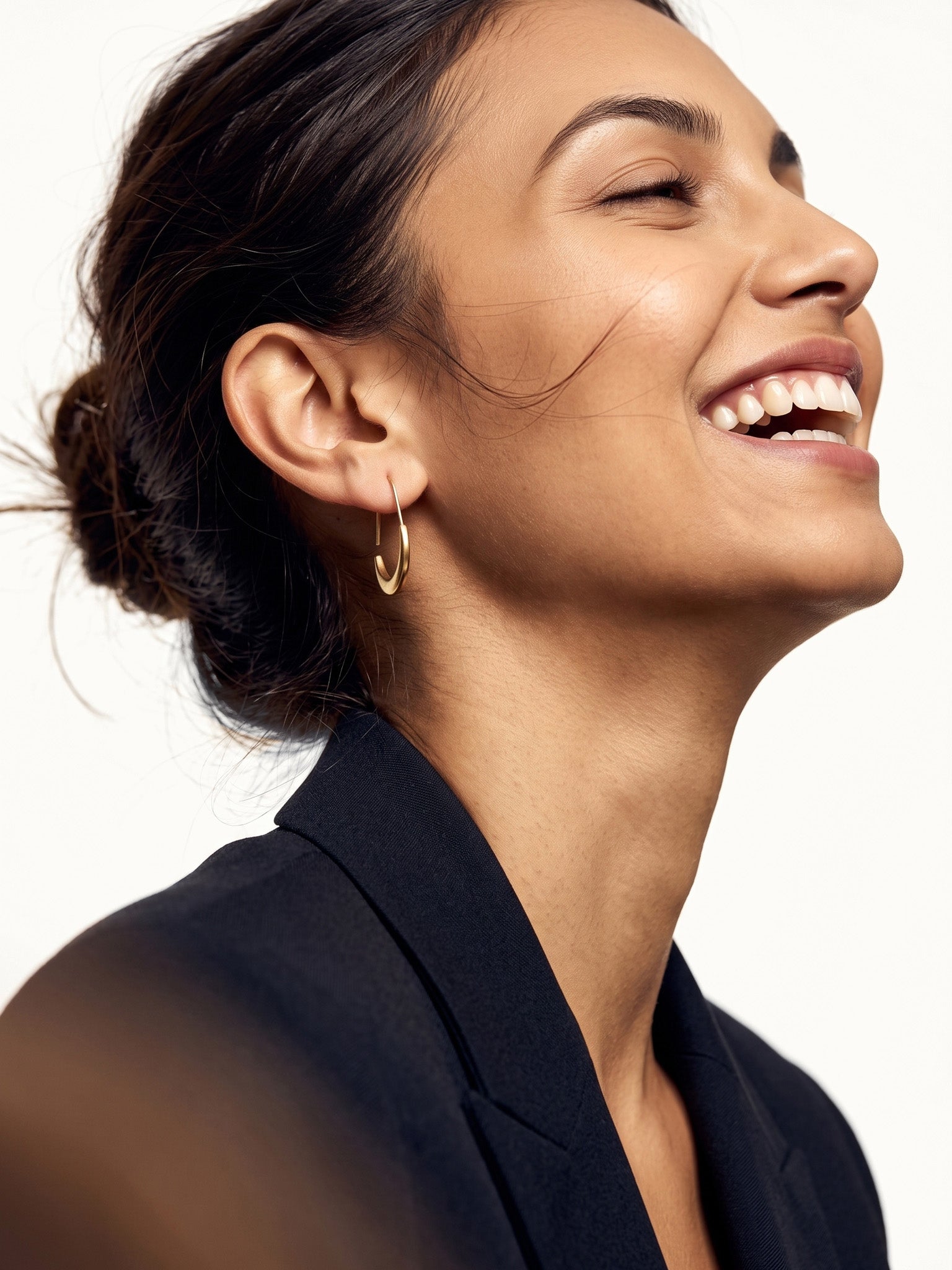 Evening Grace Drop Earrings – worn in the ear, laughing in side view, gold, hair in a low bun