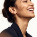 Evening Grace Drop Earrings – worn in the ear, laughing in side view, gold, hair in a low bun