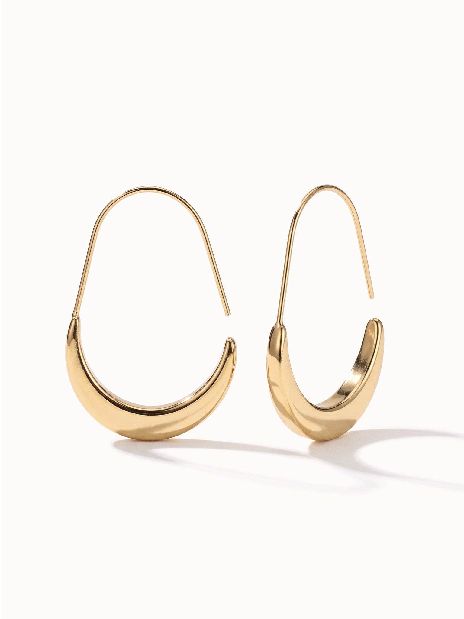 Evening Grace Drop Earrings – pair of tapered drop hoops, standing upright, gold, on ivory background