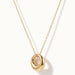 Everyday Loop Necklace – loop pendant hanging on a fine chain, turned to the side, gold, on ivory background