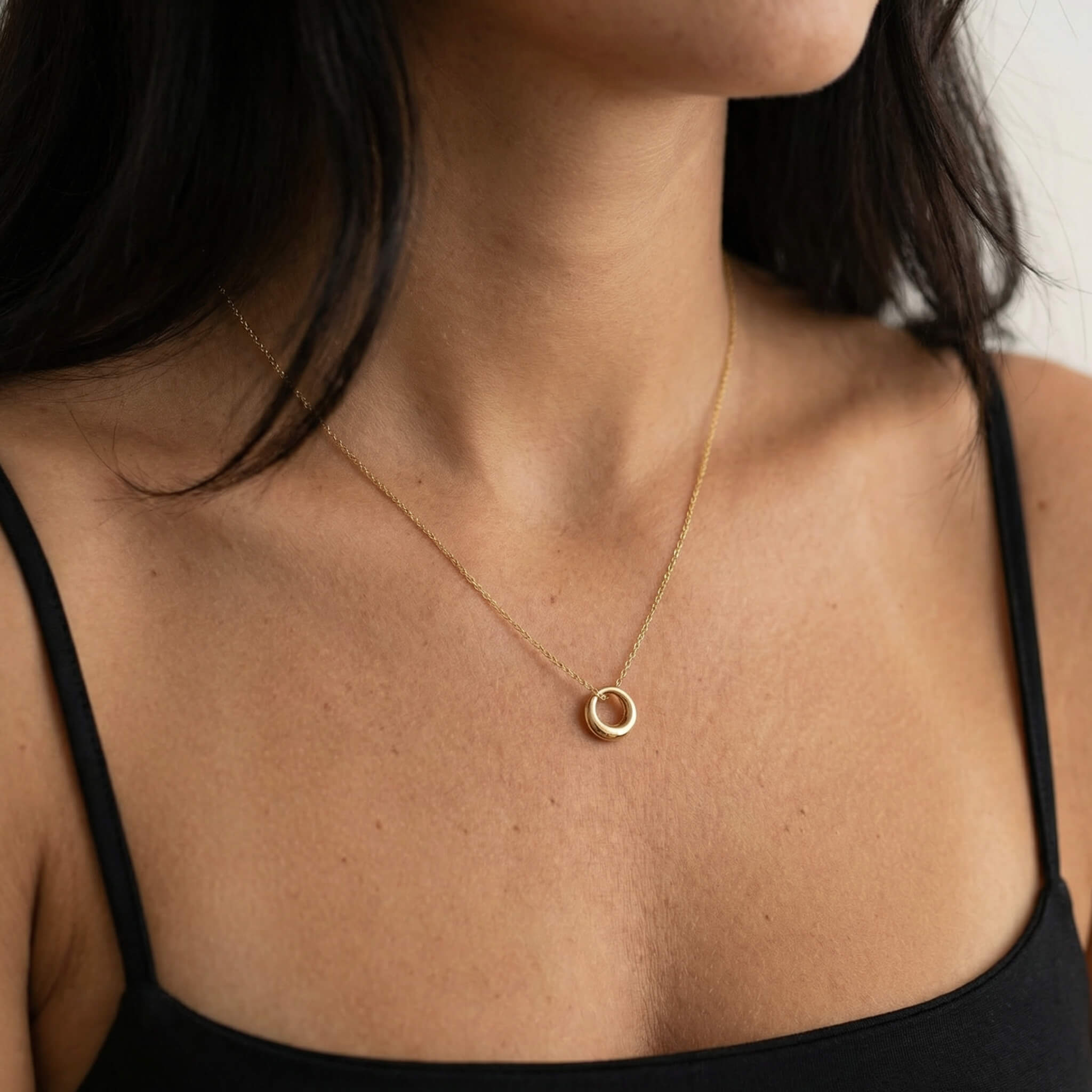 Everyday Loop Necklace worn on the collarbone with a black top