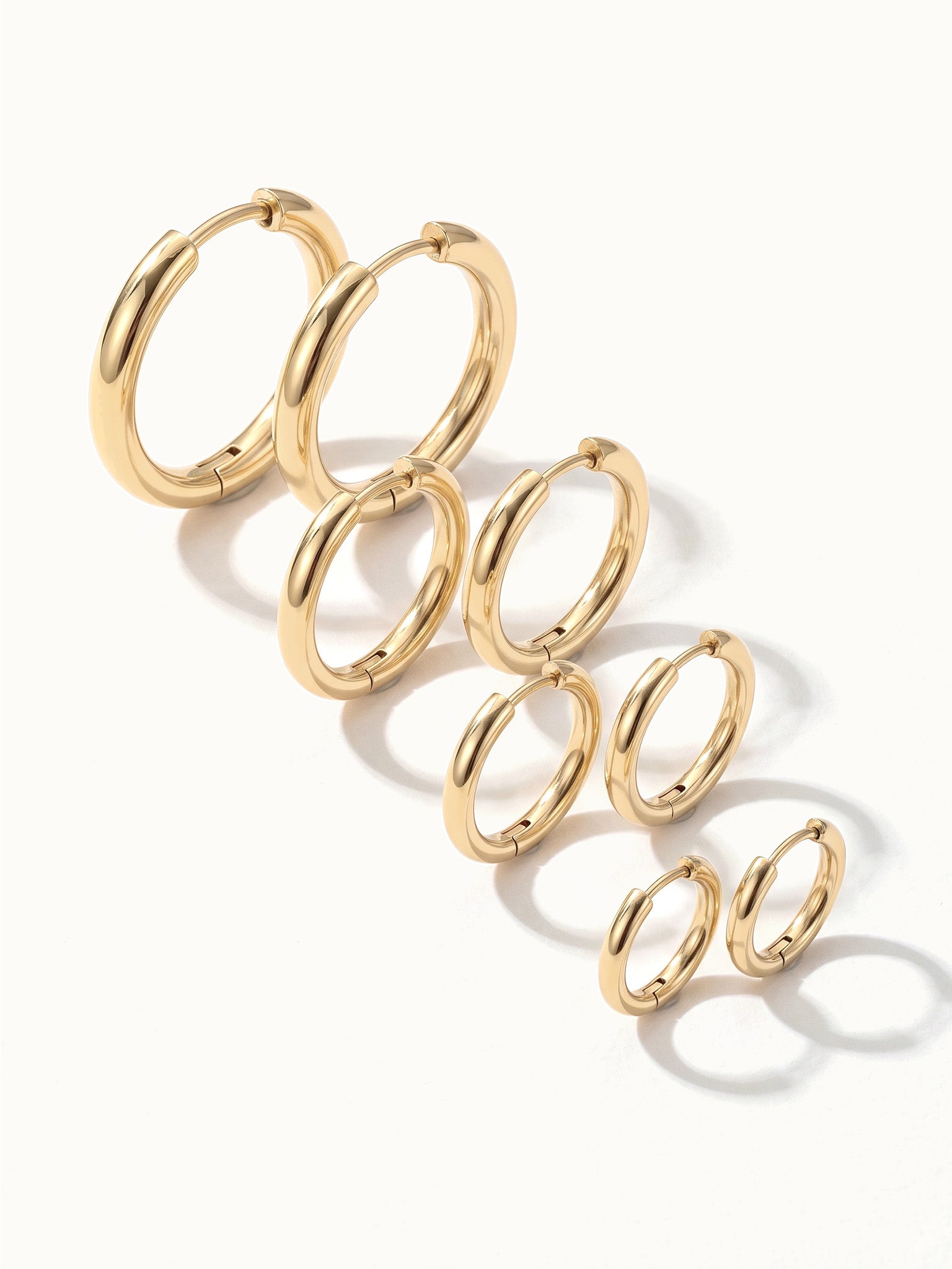 Faithful Hoops – all four sizes in a diagonal line, 12mm to 6mm, gold, on ivory background