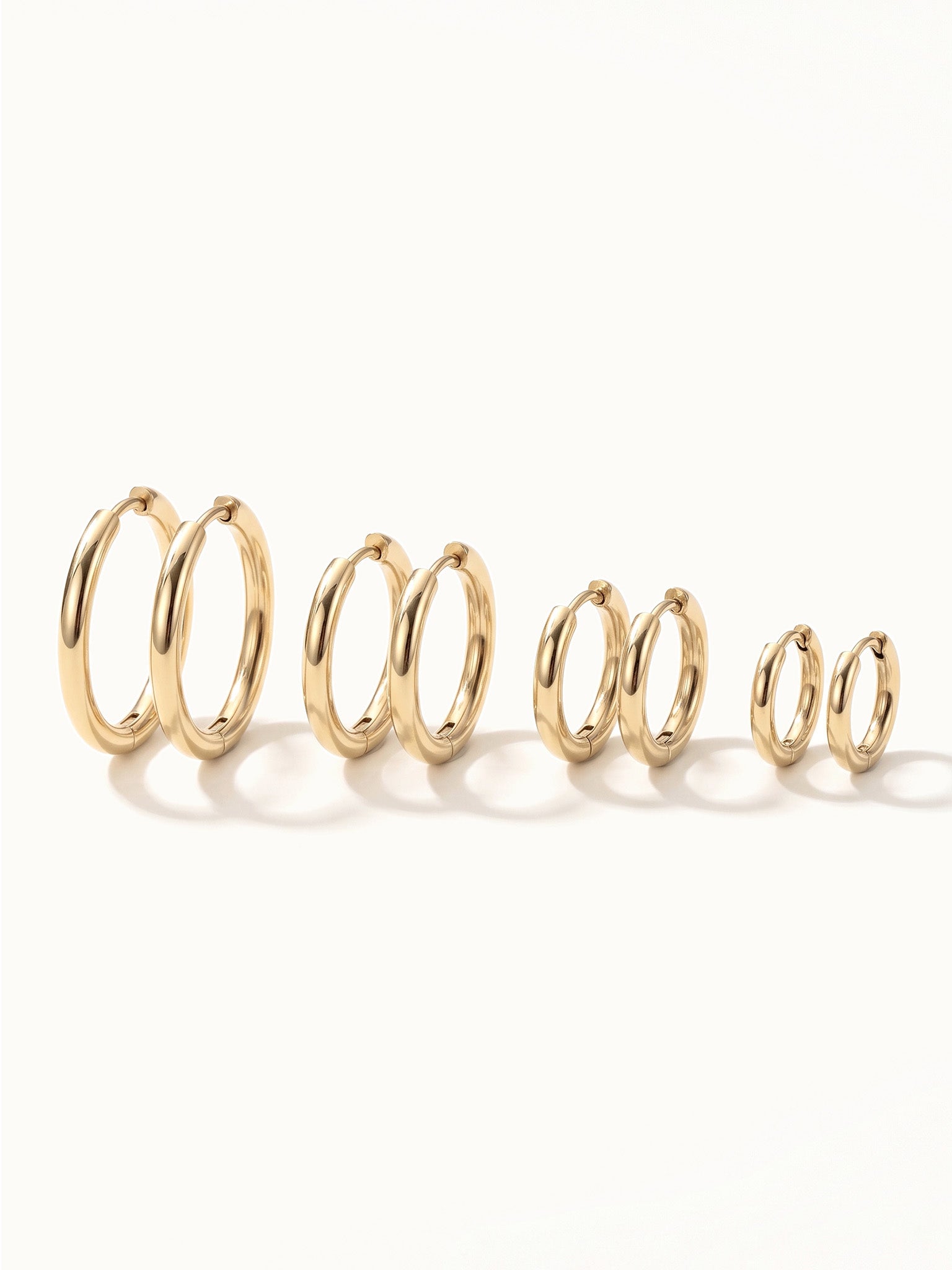 Faithful Hoops – all four sizes standing in a row, 12mm to 6mm, gold, on ivory background
