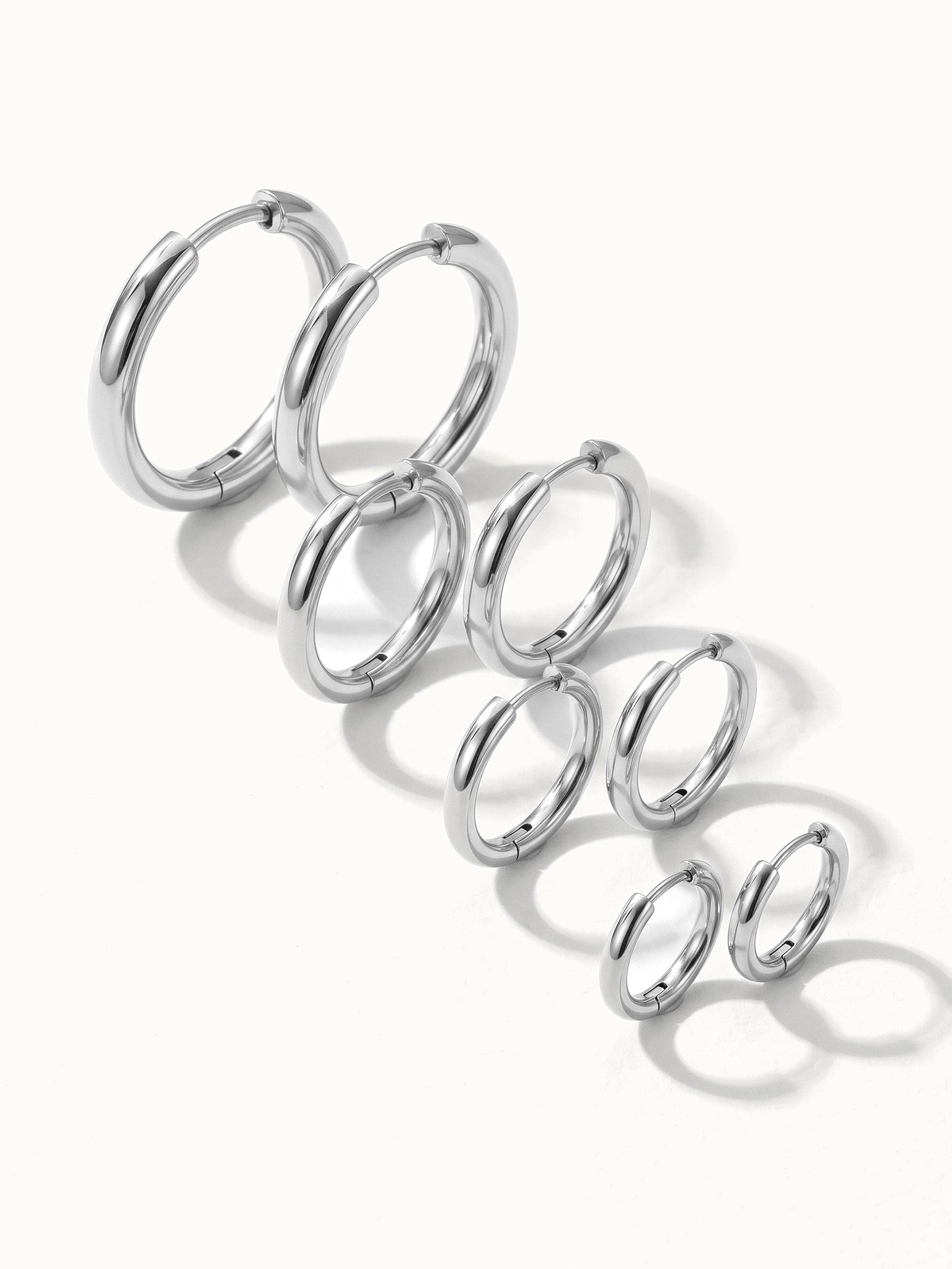 Faithful Hoops – all four sizes in a diagonal line, 12mm to 6mm, silver, on ivory background