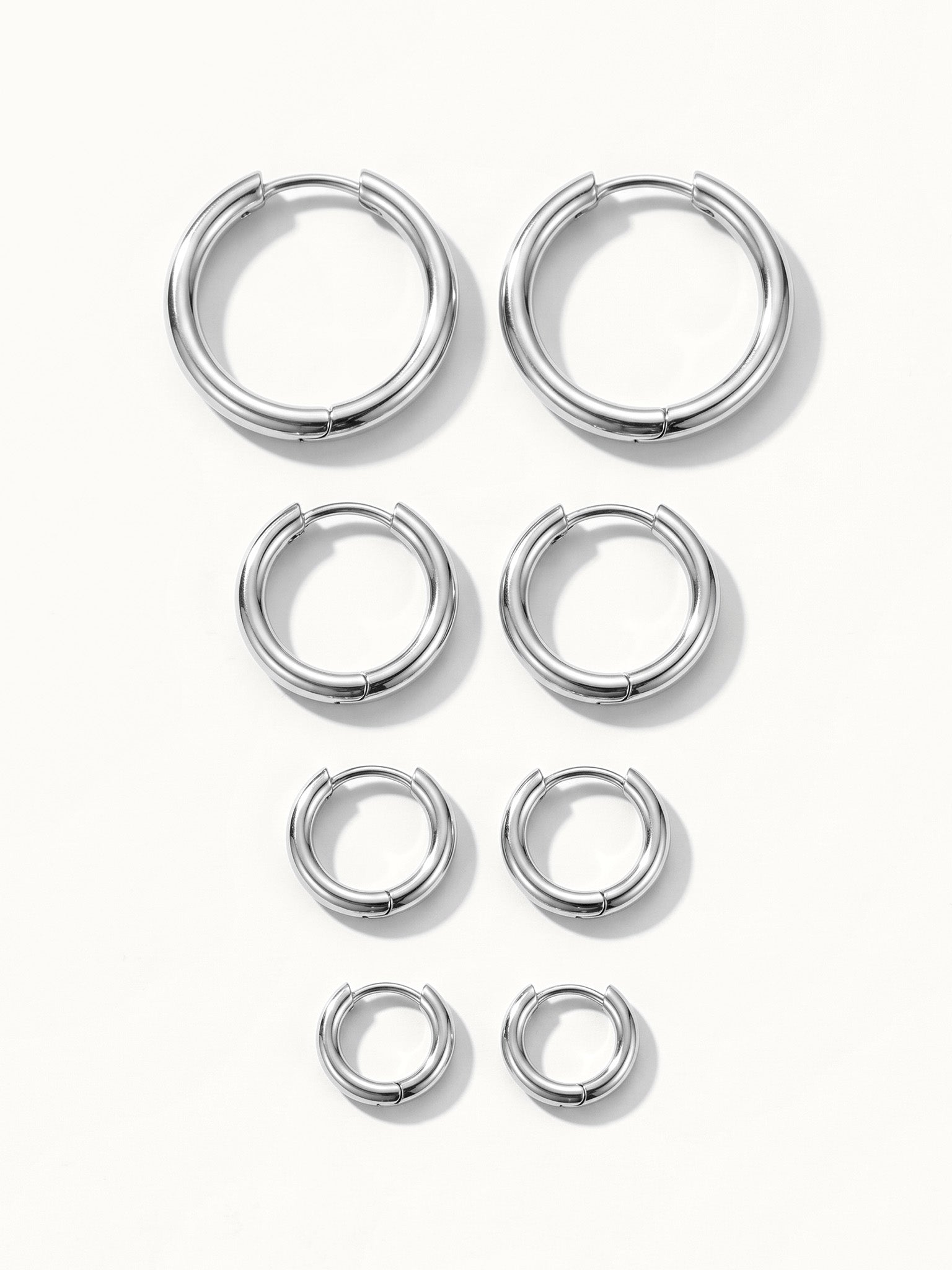 Faithful Hoops – all four sizes lying flat, 12mm to 6mm, silver, on ivory background