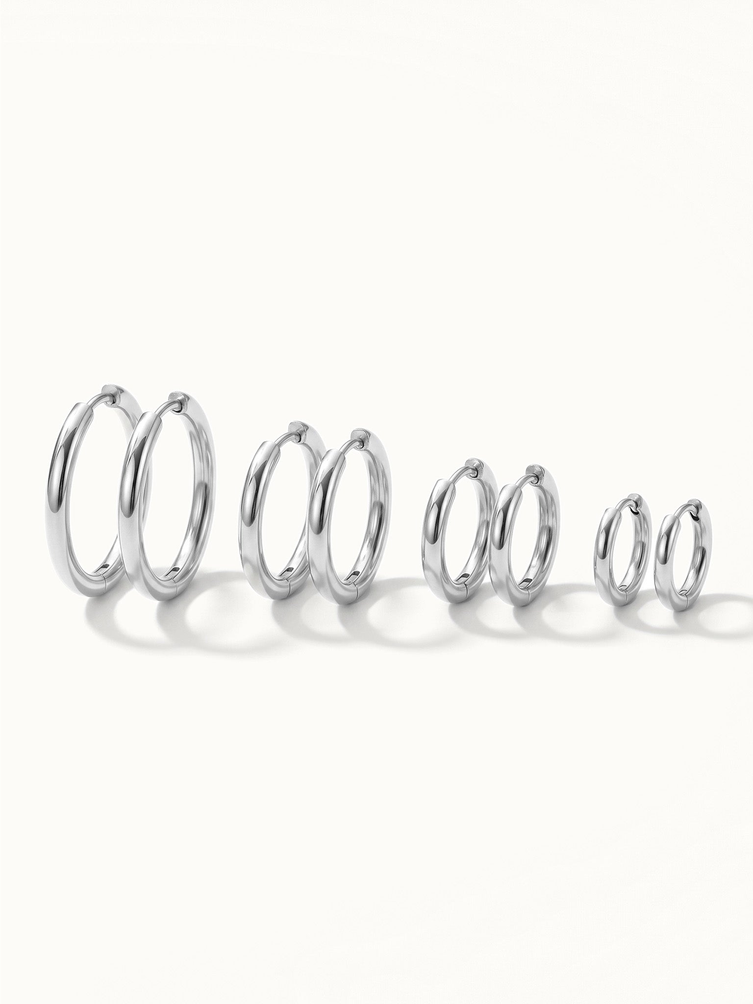 Faithful Hoops – all four sizes standing in a row, 12mm to 6mm, silver, on ivory background
