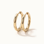 Faithful Hoops – pair of plain polished hoops, 10mm, gold, on ivory background