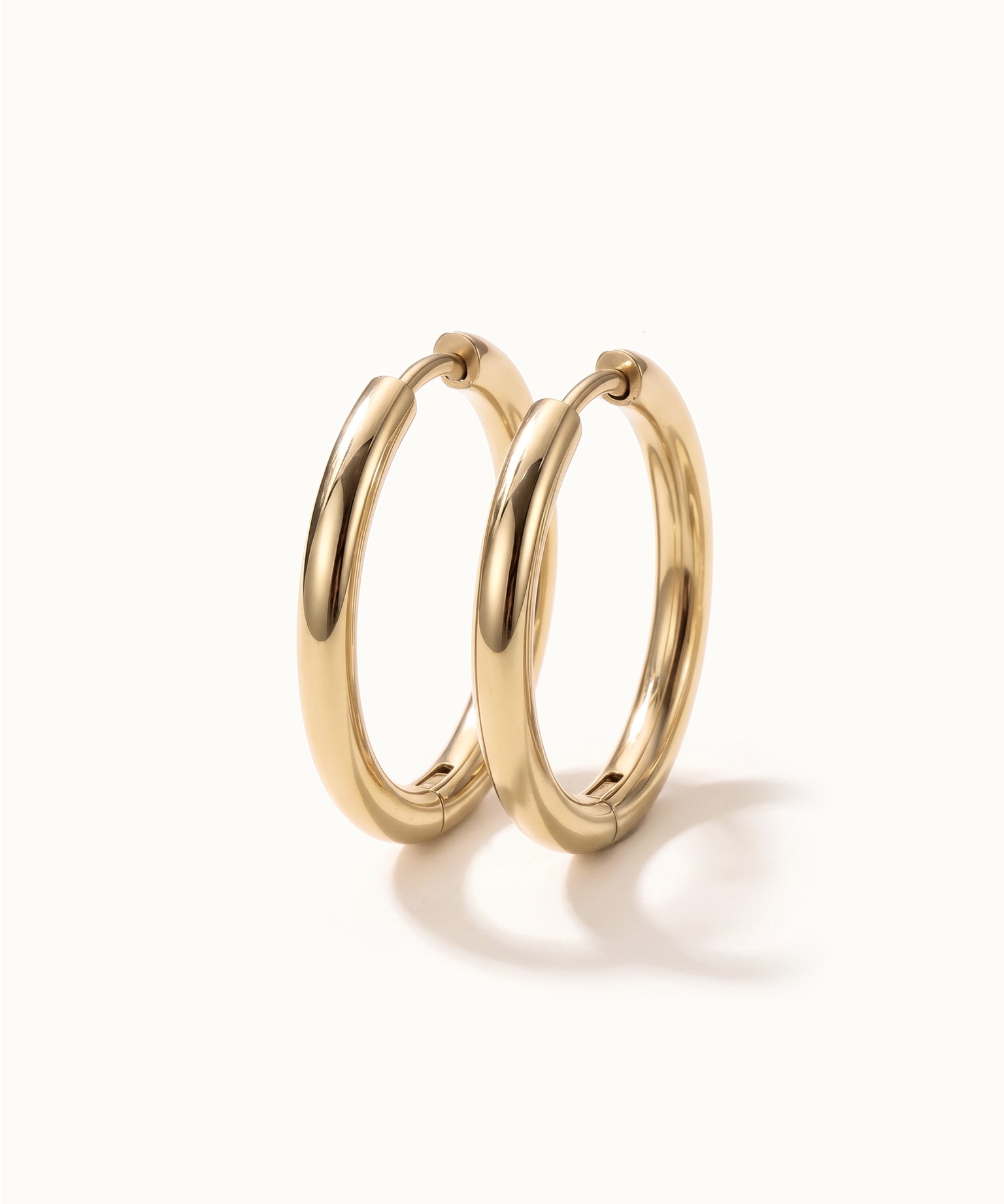 Faithful Hoops – pair of plain polished hoops, 12mm, gold, on ivory background