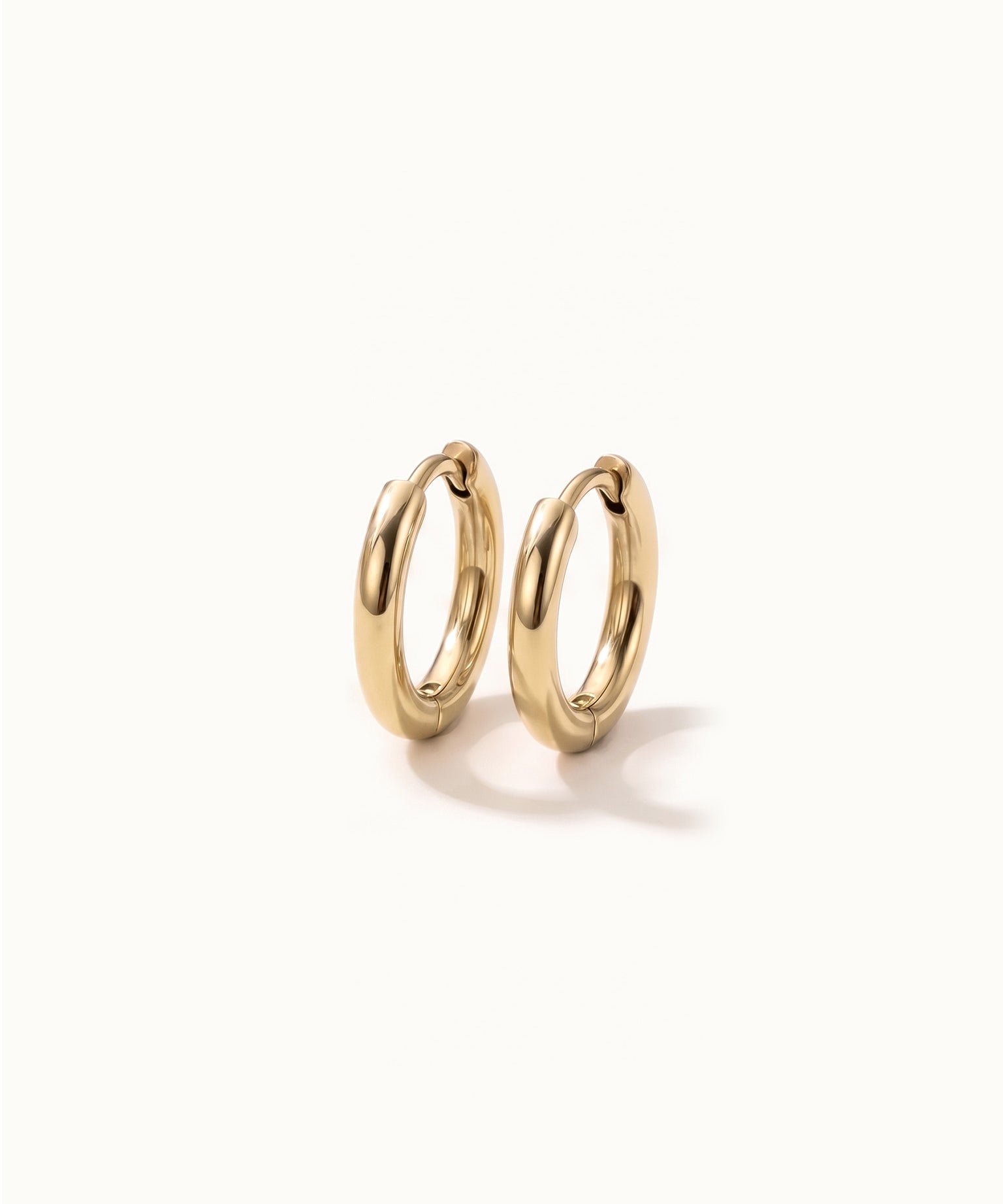 Faithful Hoops – pair of plain polished hoops, 6mm, gold, on ivory background