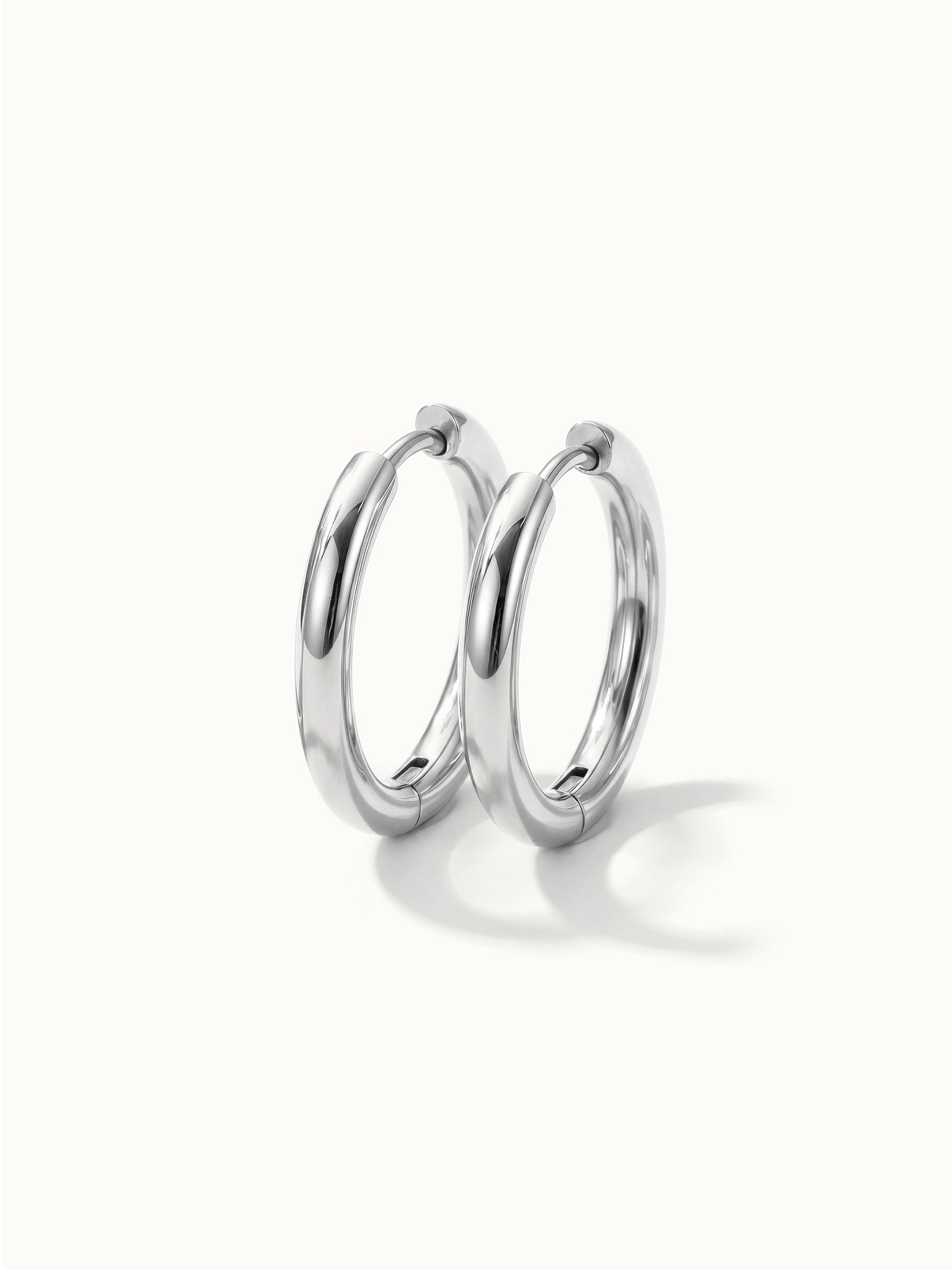 Faithful Hoops – pair of plain polished hoops, 10mm, silver, on ivory background