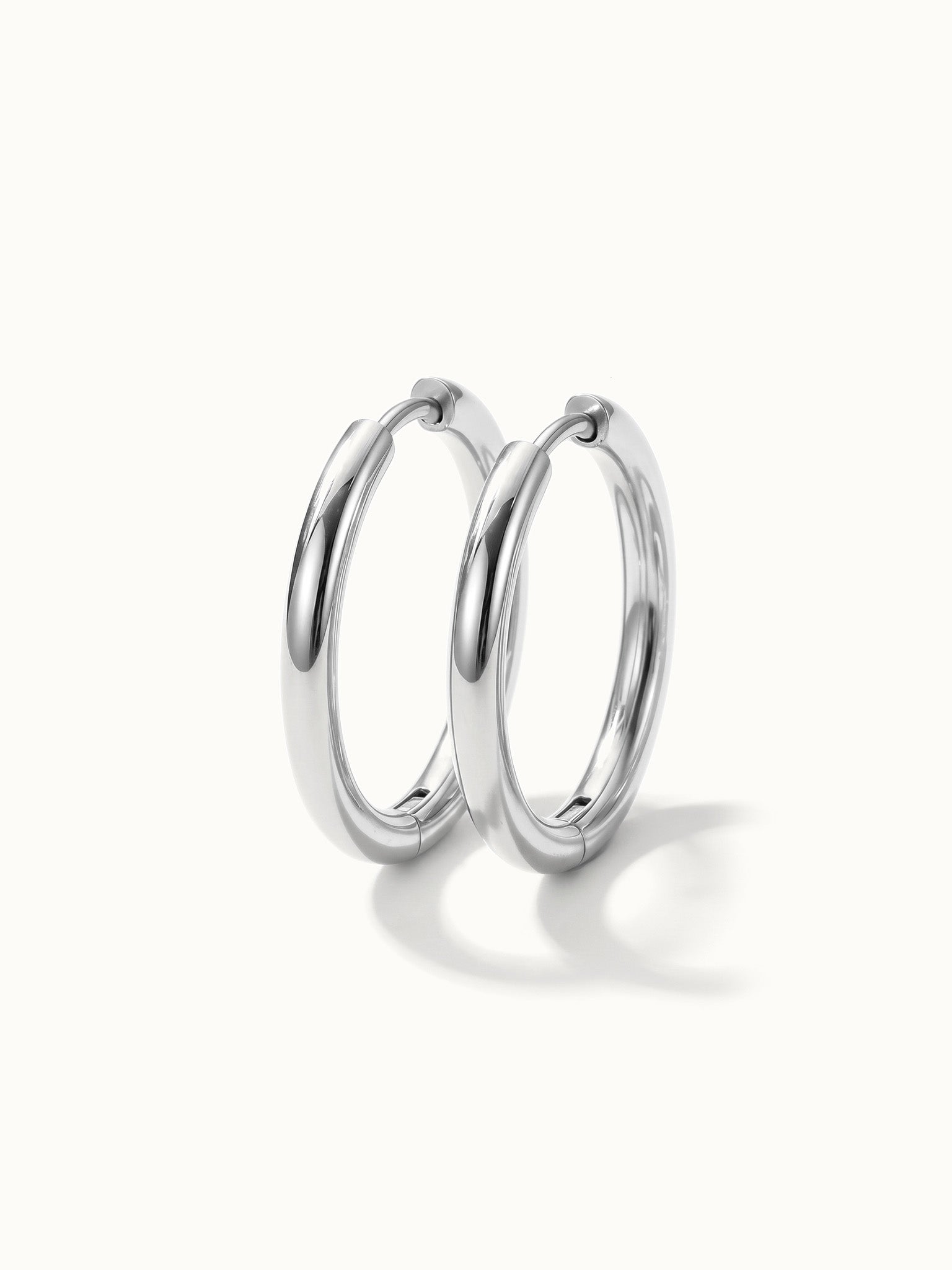 Faithful Hoops – pair of plain polished hoops, 12mm, silver, on ivory background