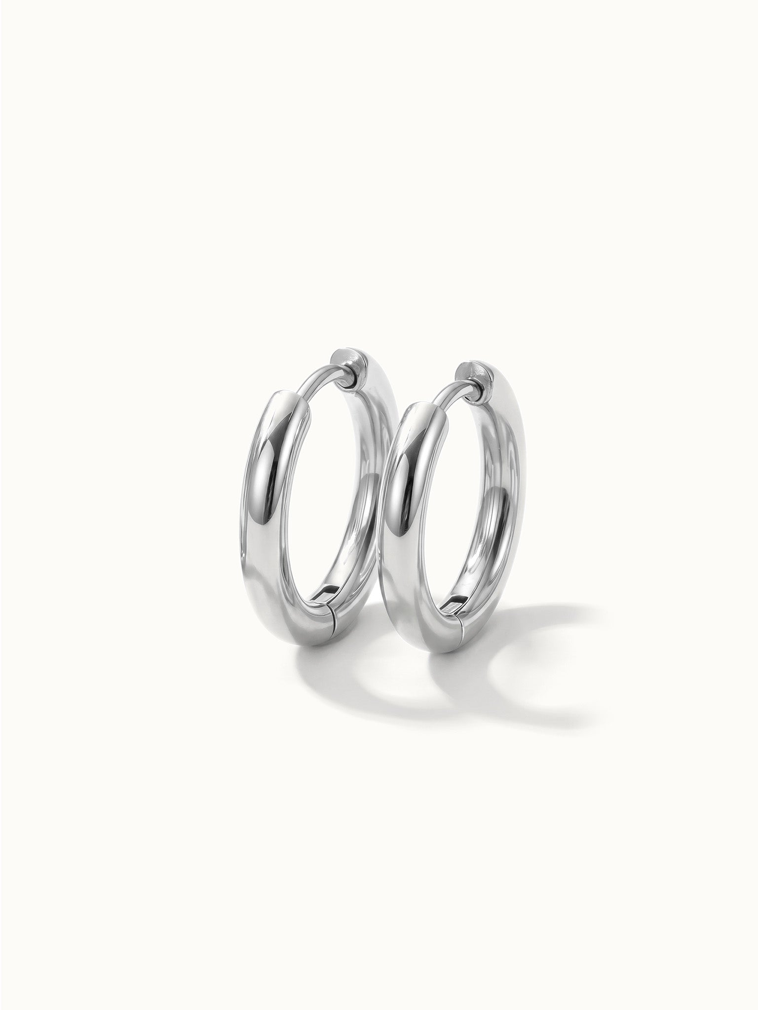 Faithful Hoops – pair of plain polished hoops, 8mm, silver, on ivory background