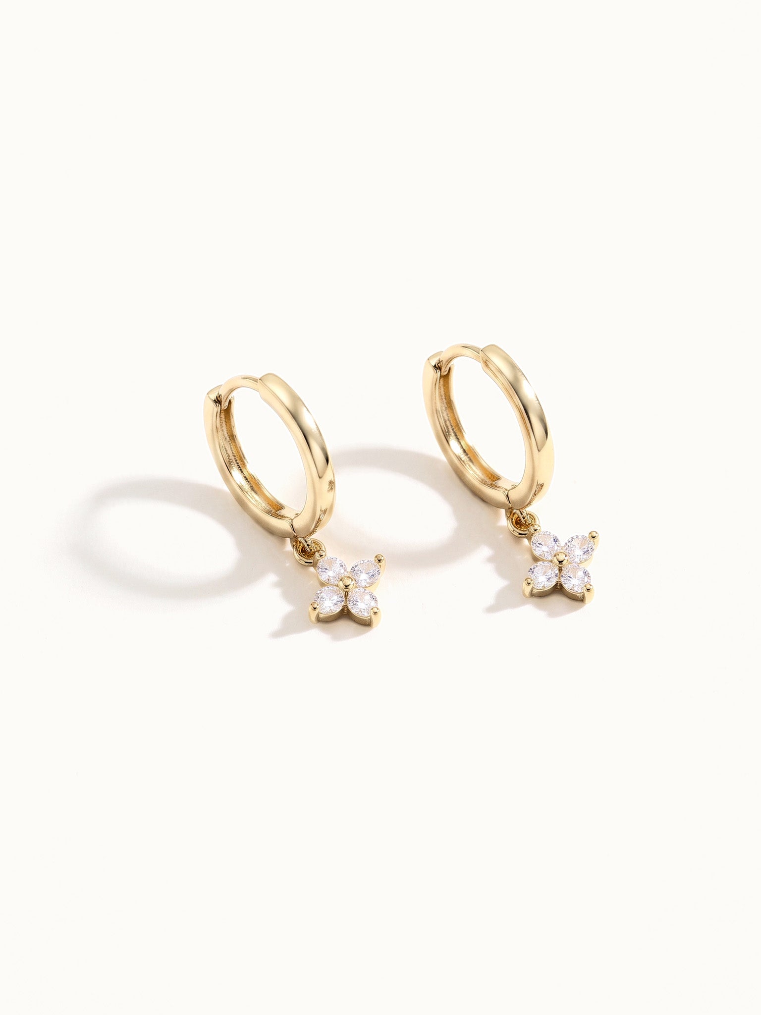 Field Lily Drop Earrings – pair of flower drop huggie hoops, standing upright, gold, on ivory background