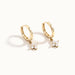 Field Lily Drop Earrings – pair of flower drop huggie hoops, standing upright, gold, on ivory background