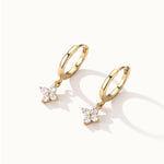 Field Lily Drops – pair of flower drop huggie hoops, gold, on ivory background