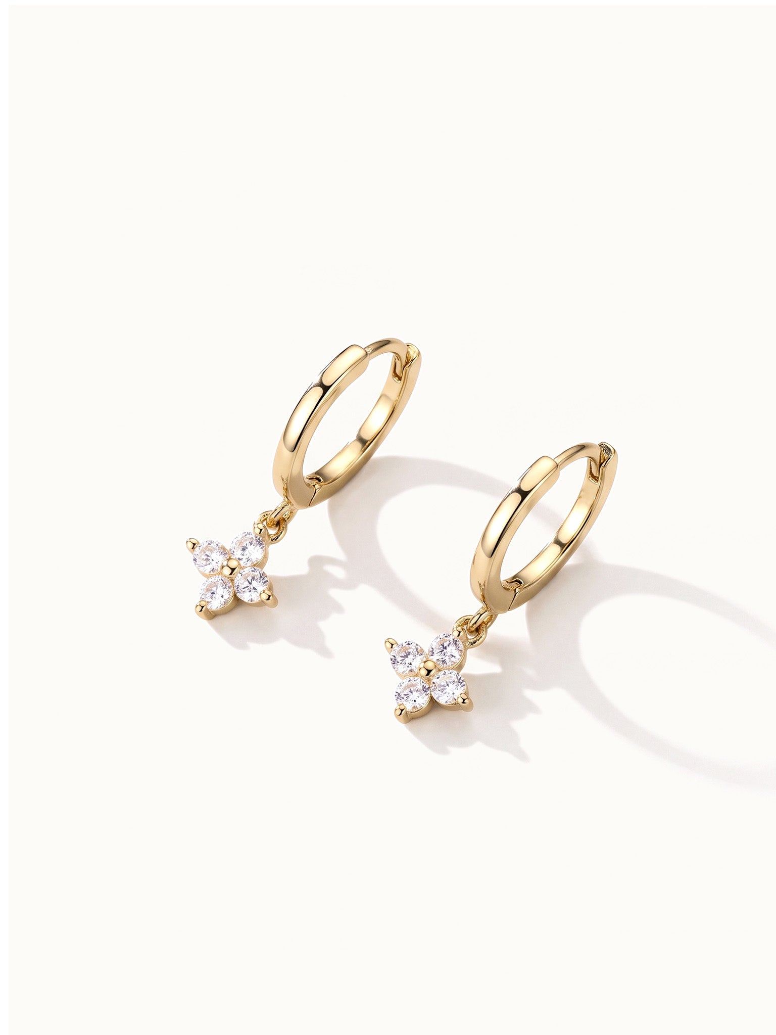 Field Lily Drops – pair of flower drop huggie hoops, gold, on ivory background