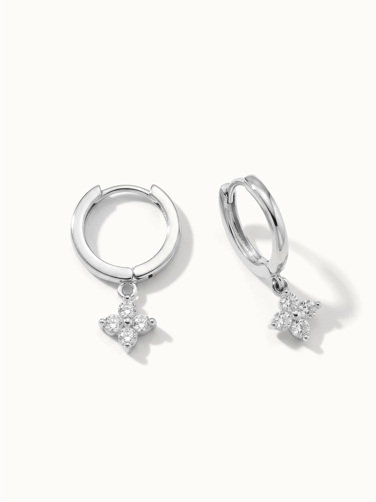 Field Lily Drop Earrings – pair of flower drop huggie hoops, close-up, silver, on ivory background