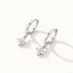 Field Lily Drops – pair of flower drop huggie hoops, silver, on ivory background