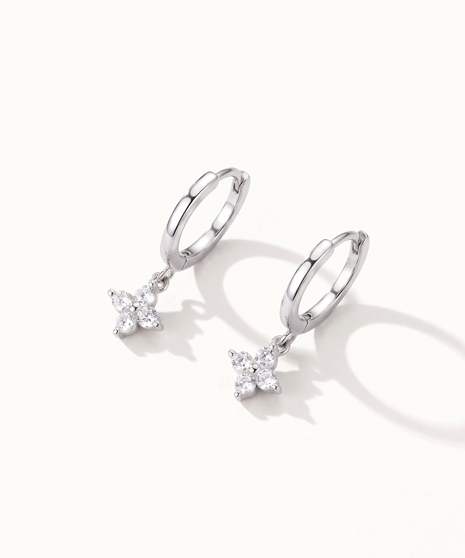 Field Lily Drop Earrings – pair of flower drop huggie hoops, silver, on ivory background