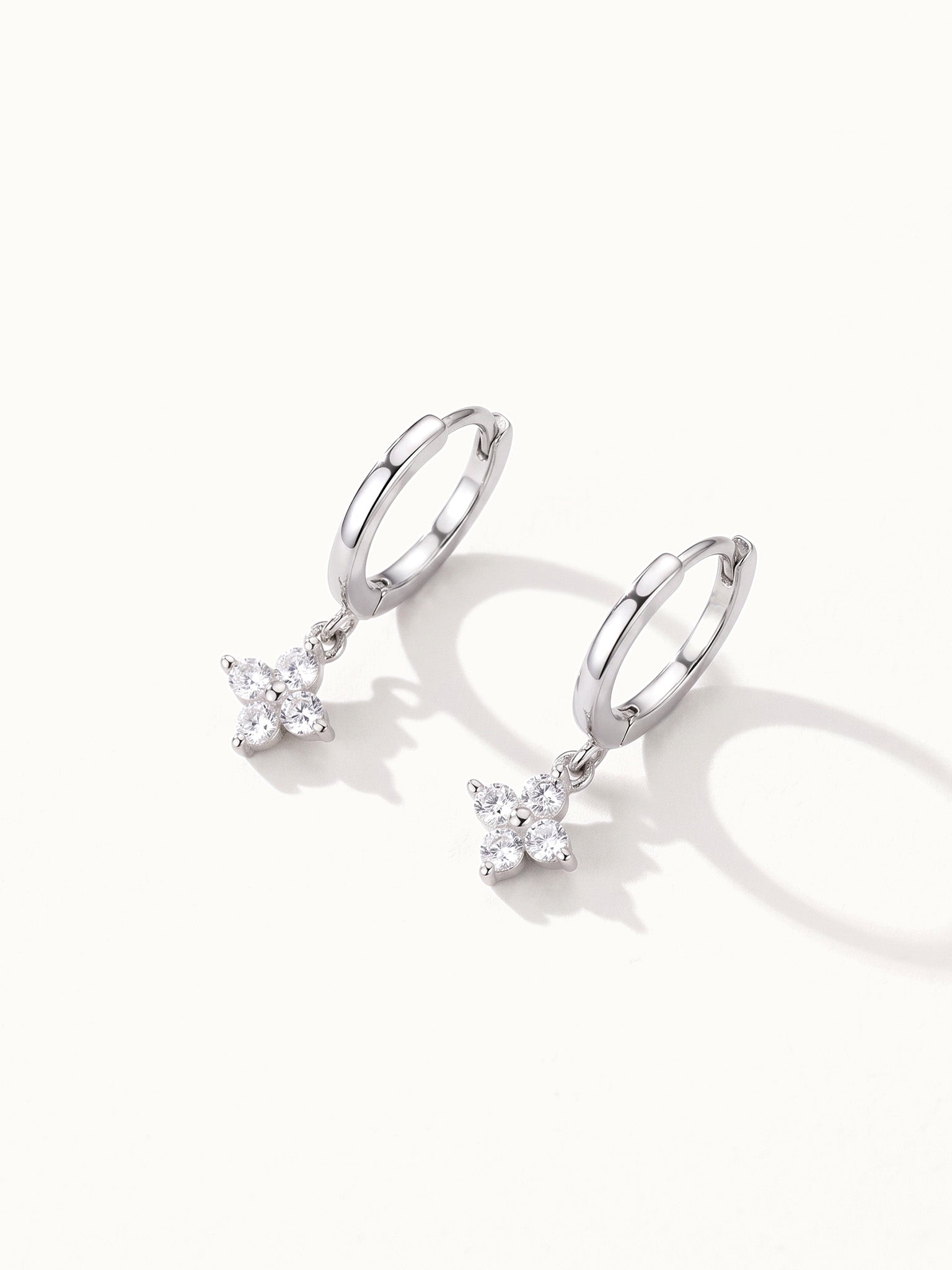 Field Lily Drops – pair of flower drop huggie hoops, silver, on ivory background