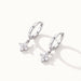 Field Lily Drop Earrings – pair of flower drop huggie hoops, silver, on ivory background