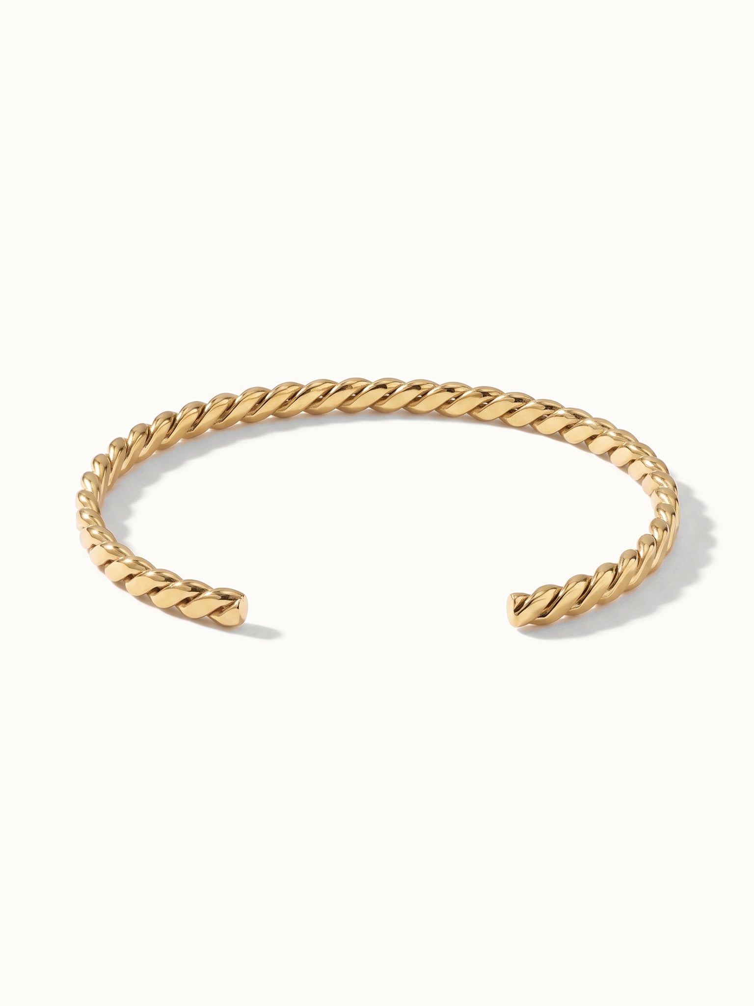 Fire & Roots Cuff – open rope-twist cuff, front view, gold, on ivory background