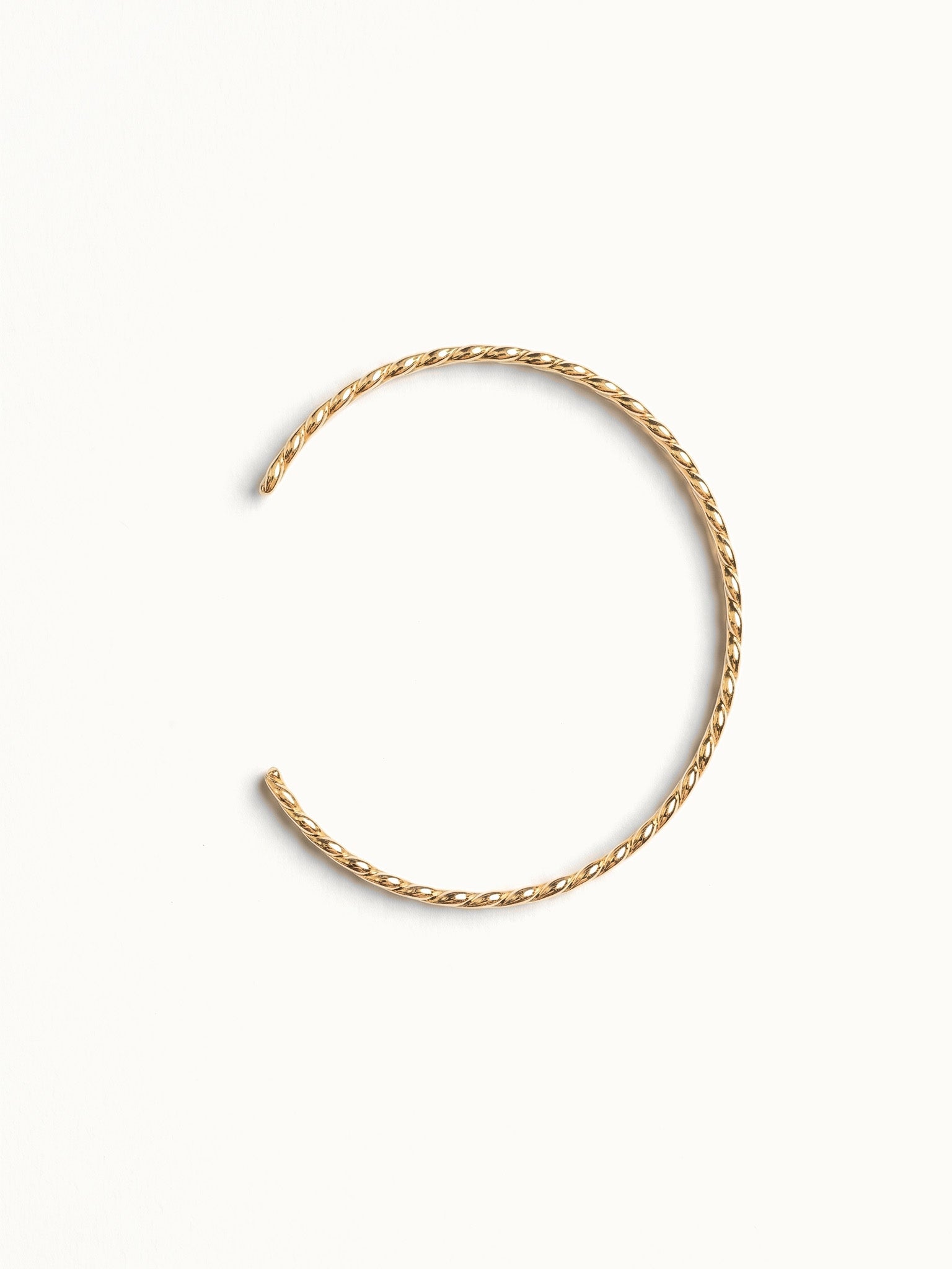 Fire & Roots Cuff – open cuff seen from above, gold, on ivory background
