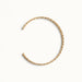 Fire & Roots Cuff – open cuff seen from above, gold, on ivory background