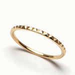 Fire Band – close-up of the faceted edge, gold, on ivory background