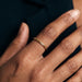 Golden Season Band Ring – worn on the hand, close-up of the woven texture, gold, dark top