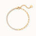 Grace Line Bracelet – laid in a circle with clasp and extender at the top, seen from above, gold, on ivory background