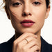 Grace Stack Ring – worn with fingers resting at the chin, gold, front view, ivory studio background