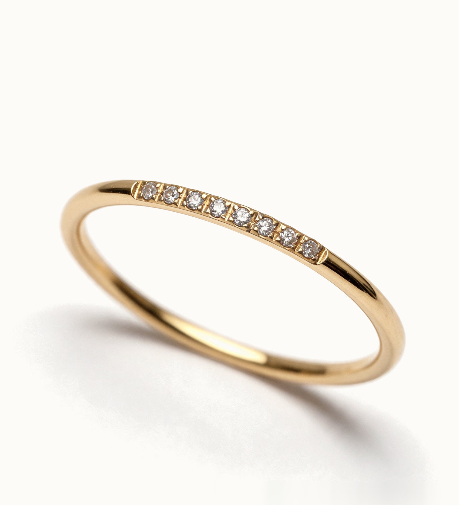 Halo Band 8-stone – close-up detail, gold, on ivory background
