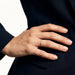 Halo Band Ring – worn with the hand resting on the hip, close-up, gold, dark blazer, ivory studio background