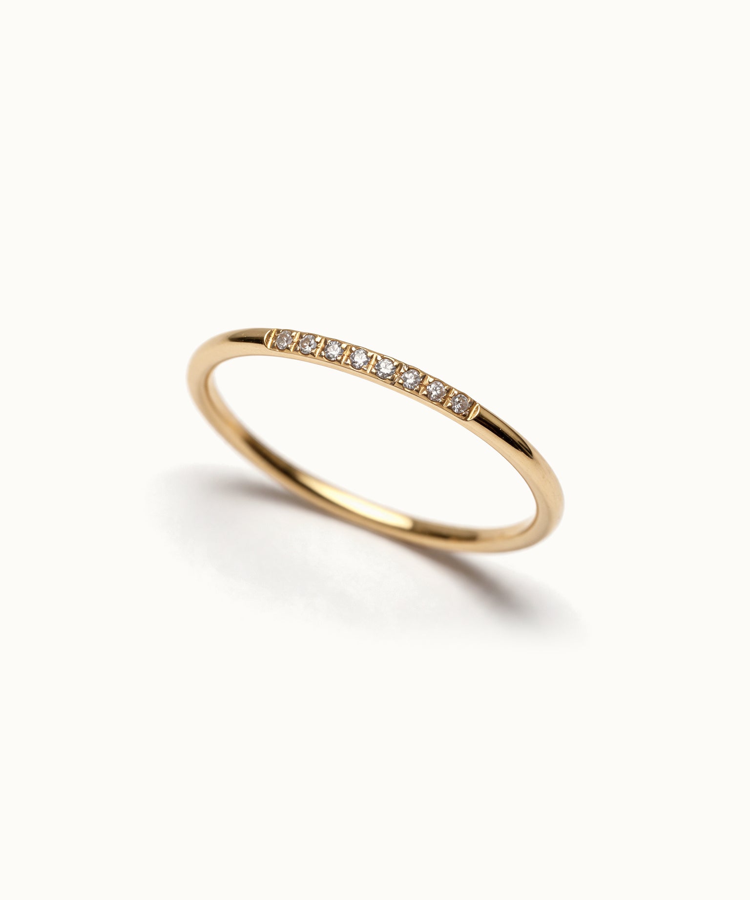 Halo Band Ring 8-stone – angled view, gold, on ivory background
