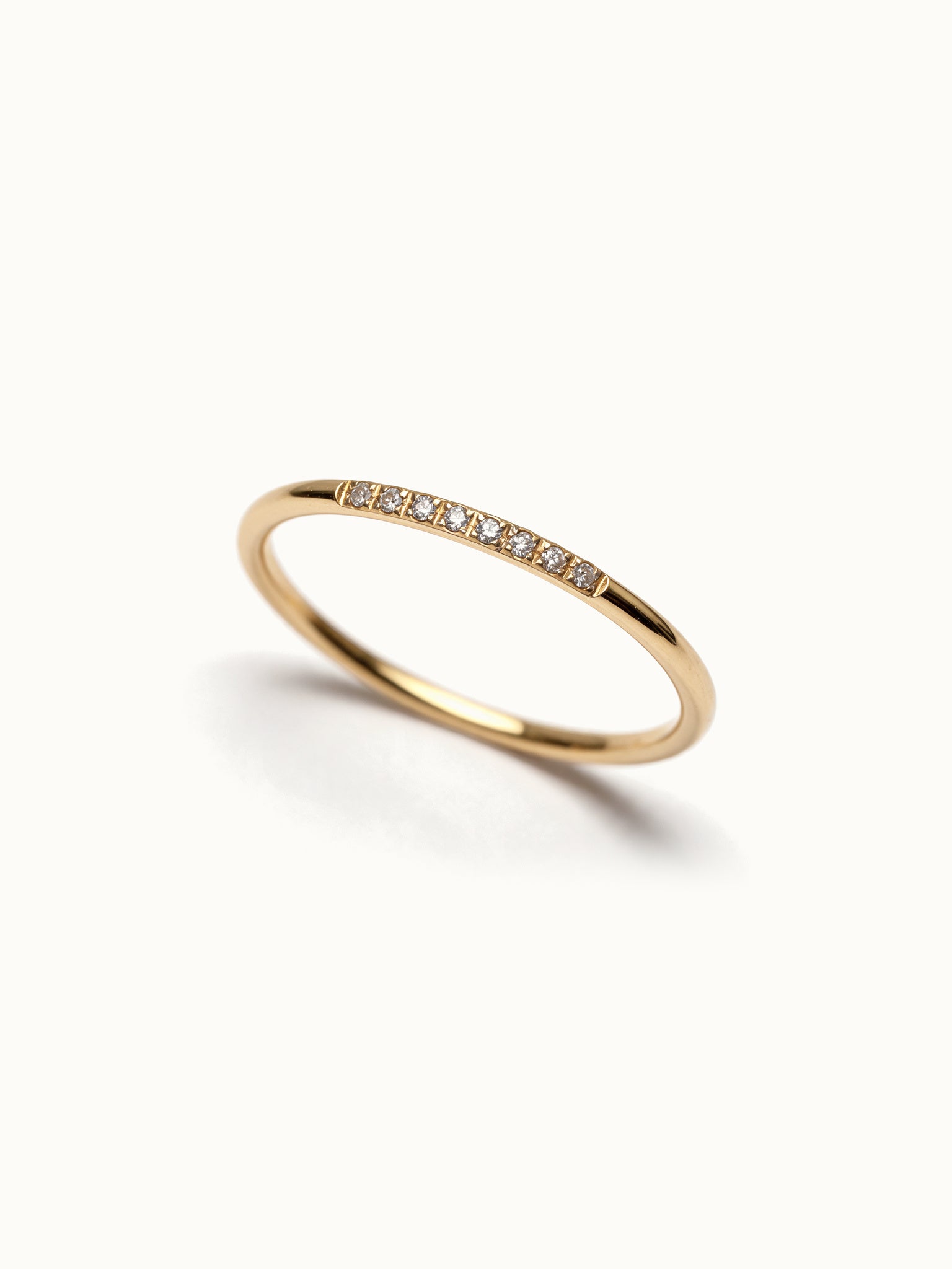 Halo Band Ring 8-stone – angled view, gold, on ivory background
