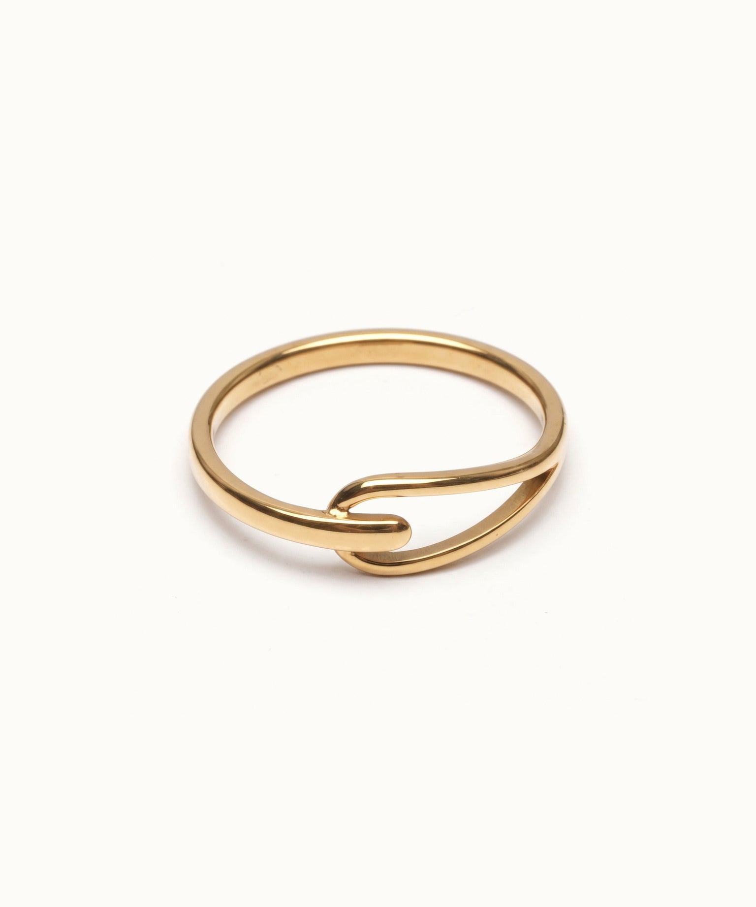 Held Ring – flat 45° view, gold, on ivory background