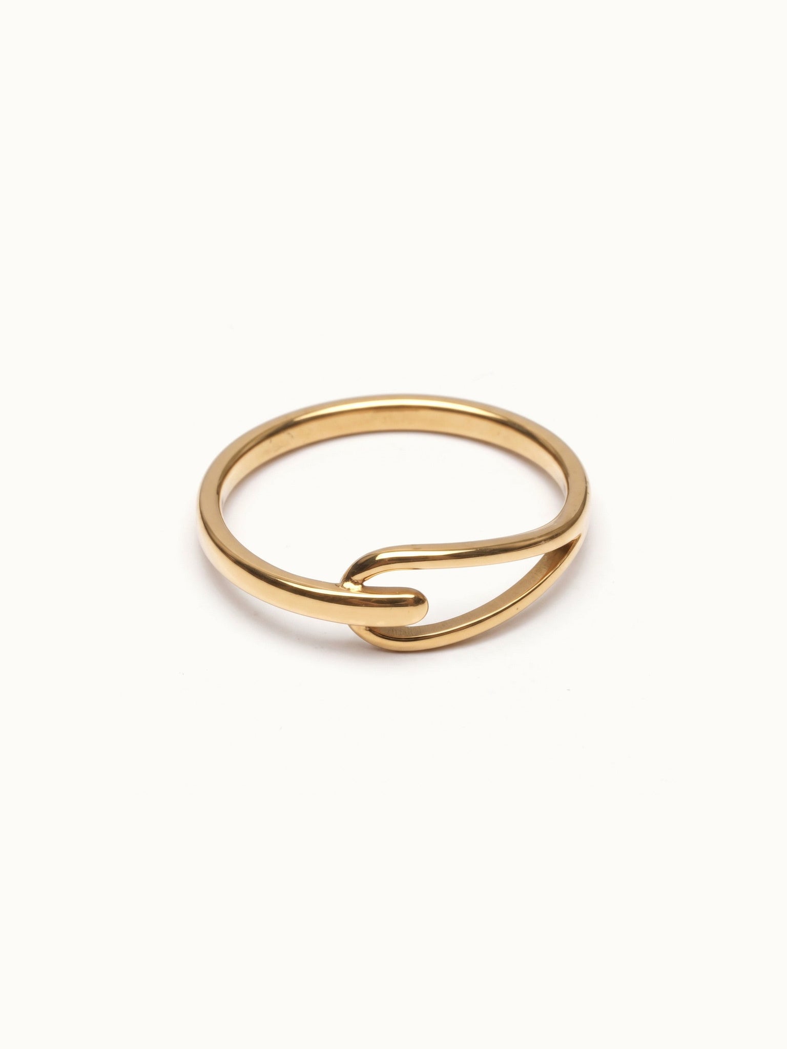 Held Ring – flat 45° view, gold, on ivory background