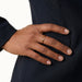 Held Ring – worn with the hand resting on the hip, gold, dark blazer, ivory studio background